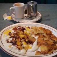 Mass Confusion · Two scrambled eggs on two biscuits with country gravy, cheddar cheese, bacon bits, and home ...