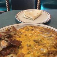 Huevos Rancheros · 2 eggs any style, tortilla, home fries, refried beans, rice, pork green chili and cheese.