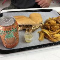 Vaca Frita Sandwich · Shredded beef with mojo, sautéed onions, and mayo topped with potato sticks on toasted Cuban...