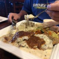 Chicken Fried Steak · Hand breaded and golden brown and smothered
with our pepper corn country gravy. Served with
...