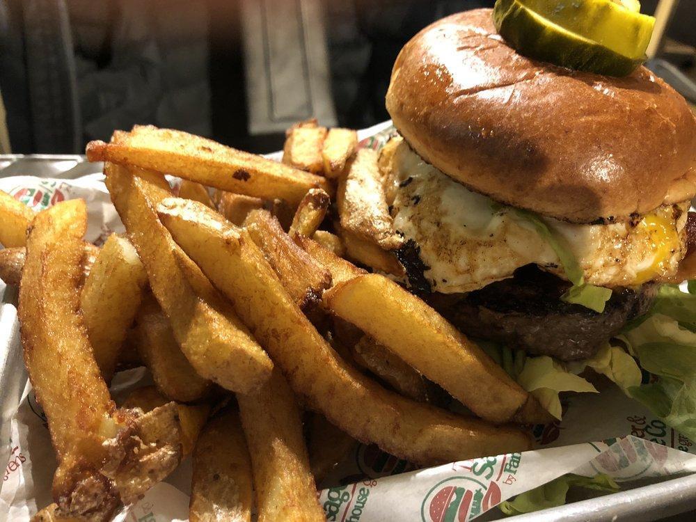 The Farmhouse Burger · Signature. Choice of protein, Leidy's thick-cut bacon, cheddar cheese, lettuce, tomato and a cage-free fried egg with jalapeno jam (mild) on a toasted pretzel bun.