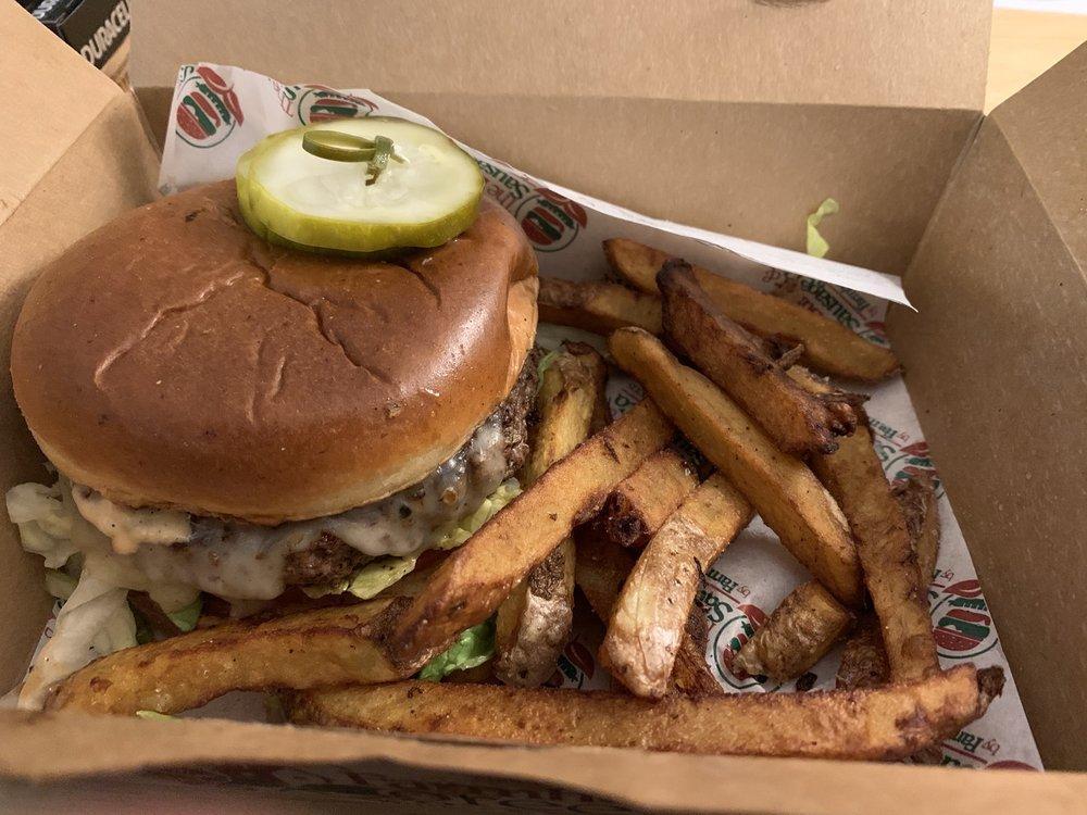 The Sin City Burger · Choice of protein, fried pickles, provolone cheese, lettuce and tomato with smoked chipotle aioli on a toasted brioche bun.