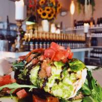 Avocado Burrata Toast · Creamy burrata and fresh avocado on toasted multi grain bread, topped with diced tomatoes, a...