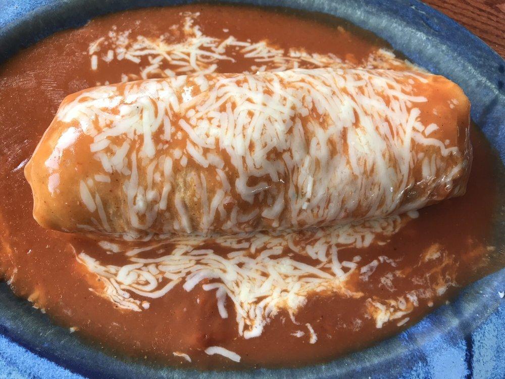 Super Mojado Burrito · Refried beans, Rice, choice of meat, sour cream, cheese, guacamole, onions and cilantro topped with enchilada sauce and cheese