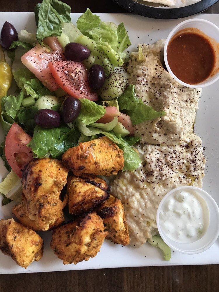 Chicken Kebab Platter · Chunks of boneless chicken breast marinated, seasoned and grilled over charcoal. Served with pita, salad, rice, hummus and babaganouj.