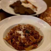 Tagliatelle Bolognese · Traditional beef ragù, parmigiano.