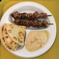 Mediterranean Chicken Kabab Platter · Tender pieces of chicken marinated in Italian herbs served over lettuce with fresh made humm...