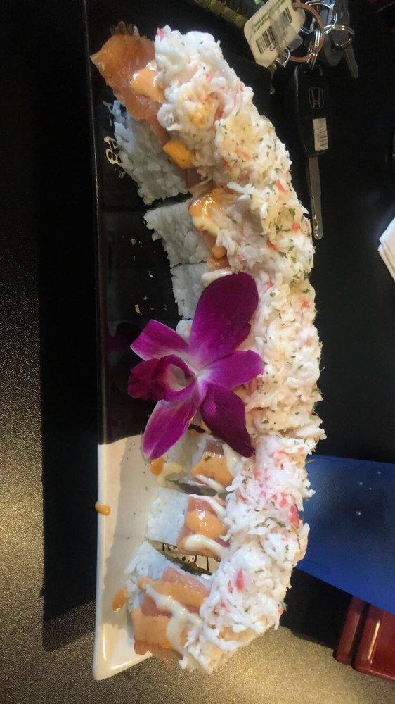 Fuji Mountain Roll · Tempura shrimp, shredded crab, cream cheese on the inside and smoked salmon, mango sauce, spicy mayo, shredded crab on the outside.