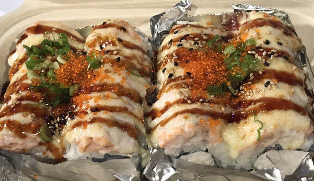 Lion King Roll · Crabmeat and avocado inside, topped with salmon, tobiko, sesame seed and scallions.