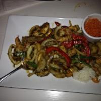 Spicy Lemongrass Seafood · Shrimp, squid and scallops, marinated with lemongrass, bell peppers, mushrooms and onions, s...