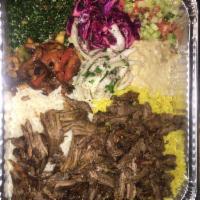 Beef Shawarma · Marinated layers of beef tenders with rice. It is served with hummus, baba ganoush, eggplant...