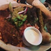 Carne Asada · Marinated and grilled skirt steak served with a cheese enchilada, 