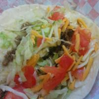 Super Taco · Crispy corn tortilla, seasoned ground beef, lettuce, shredded cheese, tomato, sour cream.