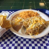 Chicken Enchilada Plate · 2 shredded chicken enchiladas topped with homemade enchilada sauce & shredded cheese, side o...