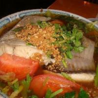 Canh Sung Vung Tau · Vung tau sour soup with catfish, celery, tomatoes, lemongrass, rice paddy herbs and black be...