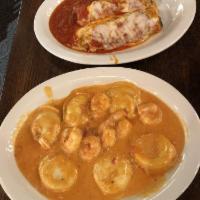 Lobster Ravioli · Lobster filled ravioli with tomato cream sauce, topped with shrimp.