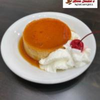 Flan · Homemade Mexican custard topped with whipped cream.