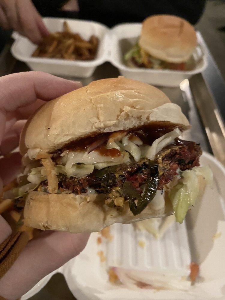 Austin BBQ Burger · BBQ, vegan cheddar, quick pickled cabbage, red onion, fried jalapenos, brioche bun.
