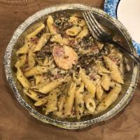 Pasta Carbonara · Prosciutto italian ham, portabella mushrooms, and fresh garlic simmered in alfredo and tosse...
