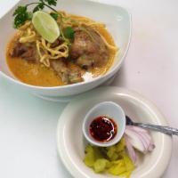 Sp3. Khao Soi Gai · Slow-cooked chicken drumsticks in a northern Thai style curry noodle soup topped with crispy...