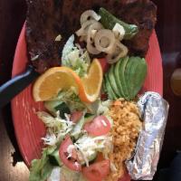 Carne Asada · A 10 oz. skirt steak char grilled to perfection topped with grilled onions, guacamole and pi...