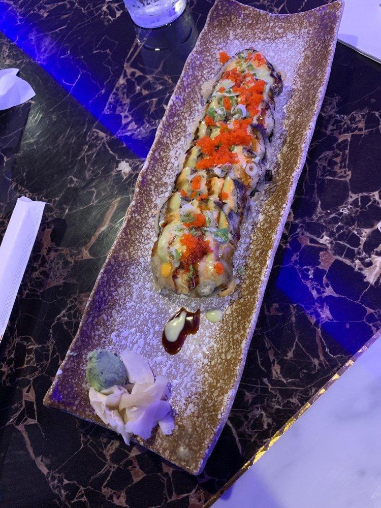 Crazy Dynamite Roll · Salmon, white fish, crabmeat, cream cheese scallion, and masago tempura-battered deep fried, topped with spicy mayo, wasabi mayo and eel sauce.