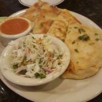 Pupusas · 2 pupusas stuffed with chicharron and cheese or chicken and cheese, grilled to golden and cr...
