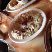 Babaganouj · Baked eggplant blended with tahini sauce and garlic. Served with fresh baked pita, olives an...