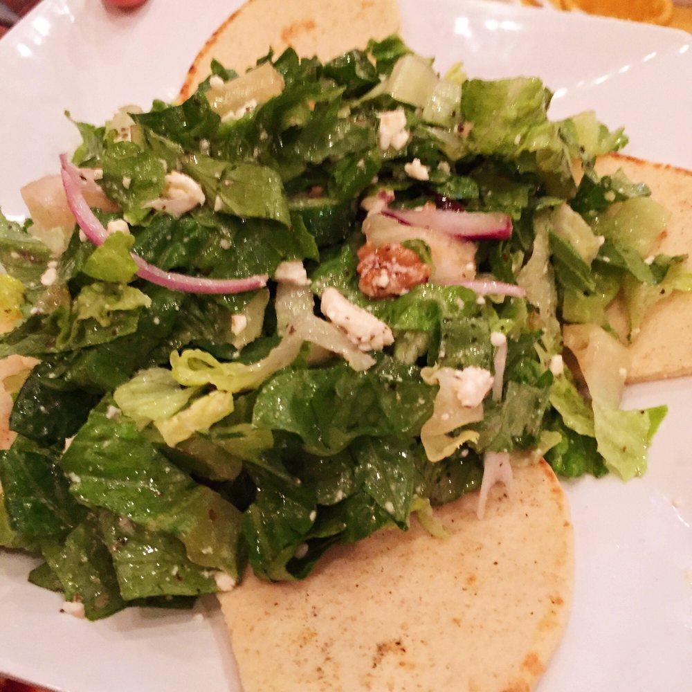 Greek Salad · Romaine, feta cheese, Kalamata olives, red onions, cucumbers, tomatoes and walnuts. Tossed with garlic vinaigrette.