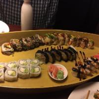 Rainbow Roll · Crab meat, avocado, and cucumber wrapped with sushi rice. Topped with tuna, salmon, snapper,...