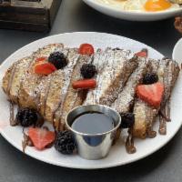 Nutella French Toast · Nutella, whole grain bread, topped with seasonal berries and powdered sugar.