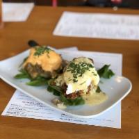 Eggs Cochon · Apple-braised pork debris served over a buttermilk biscuit, topped with two poached eggs and...