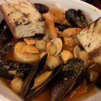 Cioppino · Traditional seafood stew in a light, spicy tomato sauce, and garlic (mussels, clams, shrimp,...