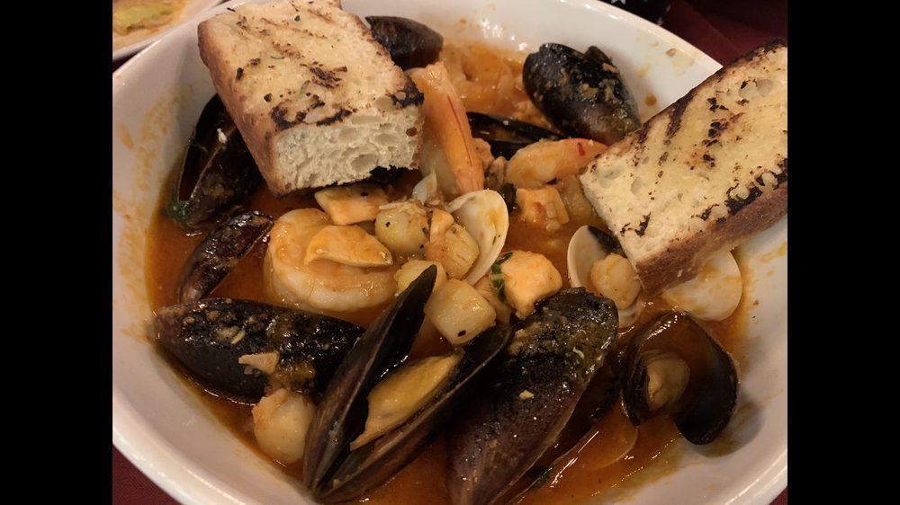 Cioppino · Traditional seafood stew in a light, spicy tomato sauce, and garlic (mussels, clams, shrimp, scallops).