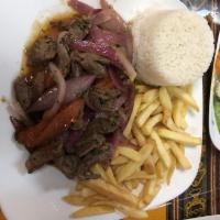 Lomo Saltado · Sauteed beef loin, pieces of fried beef mixed with onions, tomatoes and french fries.