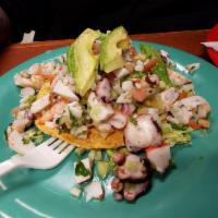 Tostada · Crispy corn tortilla topped with beans, choice of meat, lettuce, sour cream, guacamole, sals...