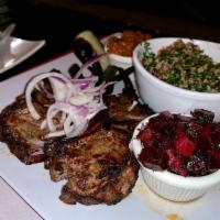 4 Piece New Zealand Lamb Chops Plate · Lamb chops served with hummus, rice, salad, onion and pita bread.