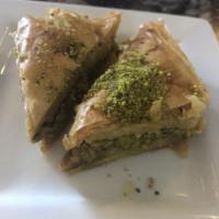 Baklava · Buttery layers of phyllo dough filled with nuts and draped in floral syrup.