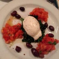 Burrata · Burrata served with black olives, chopped tomatoes and spinach 