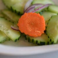Cucumber Salad · Fresh cucumber, carrots and red onion in delicious tangy sweet dressing.