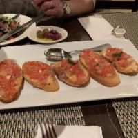 Bruschetta · Toasted Tuscan bread topped with chopped tomatoes, onions, oregano, basil and extra virgin o...