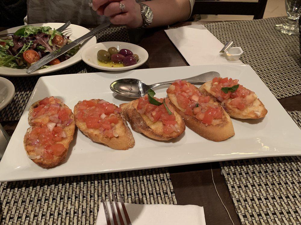 Bruschetta · Toasted Tuscan bread topped with chopped tomatoes, onions, oregano, basil and extra virgin olive oil.