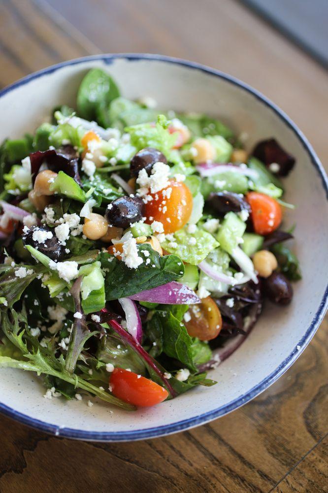 Mediterranean Salad · Romaine lettuce, cucumbers, tomatoes, red onions, garbanzo beans and olives topped with feta cheese and our house vinaigrette dressing. Served with baked pita.