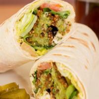 Falafel Wrap · 4 falafel balls wrapped with hummus, lettuce, tomatoes and tahini. Wraps may be made in lava...