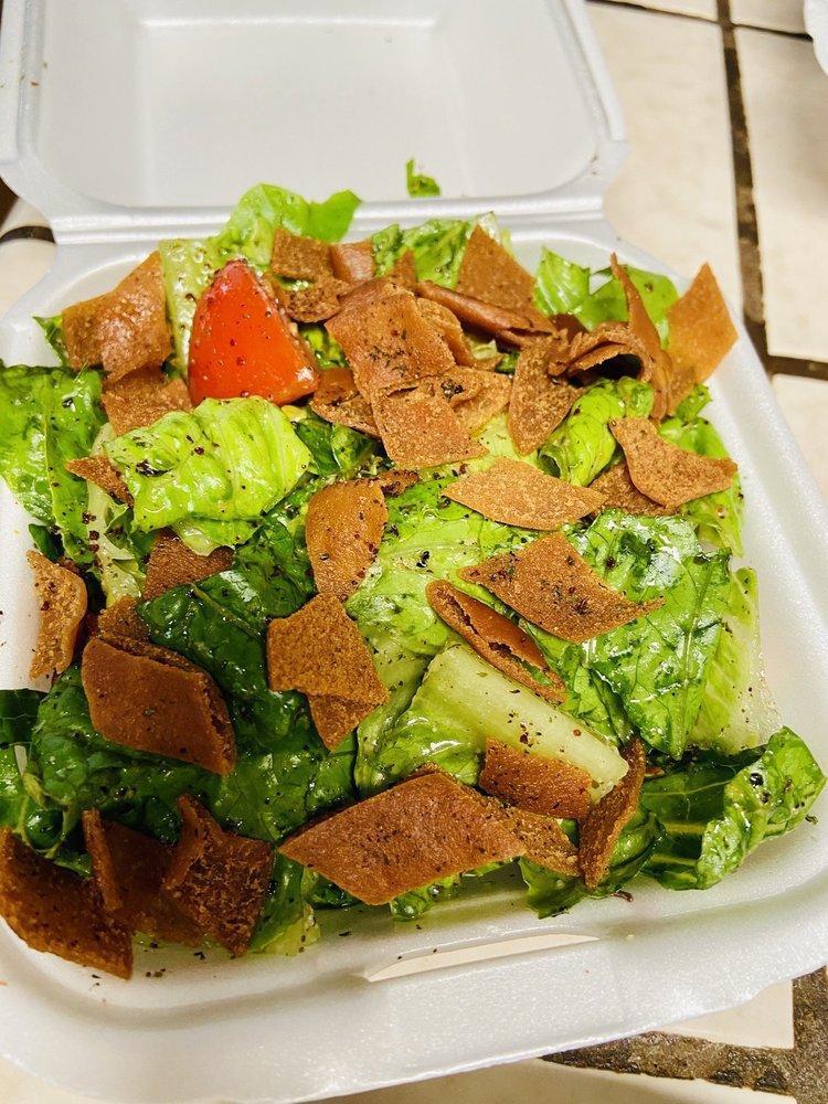 Fattoush Salad · Chopped fresh Romaine lettuce, tomatoes, cucumbers, mint, seasoned fried pita chips and tossed with a zesty lemon and olive oil dressing.