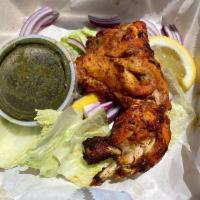 Tandoori Chicken · Marinated bone in chicken leg quarters, broiled in the tandoor oven, served in sizzling plat...