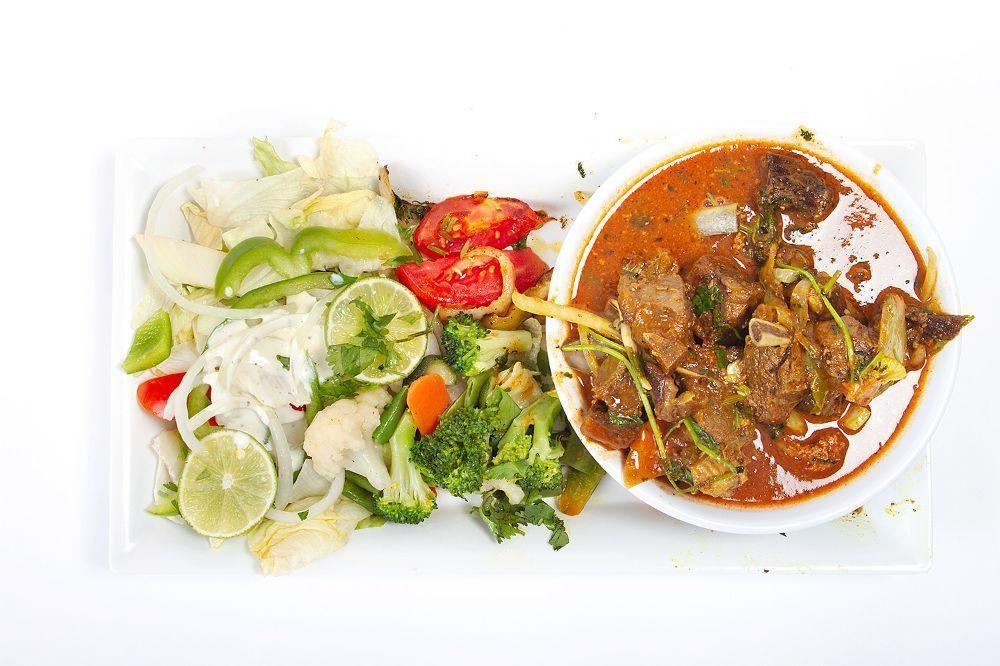 Curry Goat · Cubes of goat meat in bones cooked with our specialty blended curry sauce.