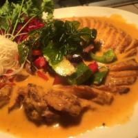 Panang Curry Duck · Roasted duck with panang curry cream sauce and sauteed vegetables. Served with steamed jasmi...