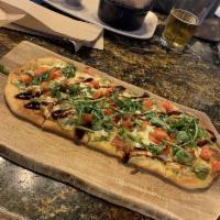 Margherita Flatbread · Freshly diced tomato and mozzarella over a basil and pine nut pesto, drizzled with a sweet b...