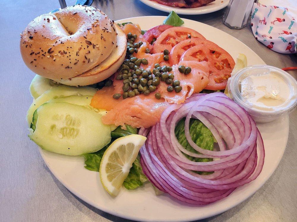 Nova Lox Platter · Nova smoked salmon, lettuce, tomatoes, cucumbers, red onion, capers, and lemon wedges served with a bagel and cream cheese.